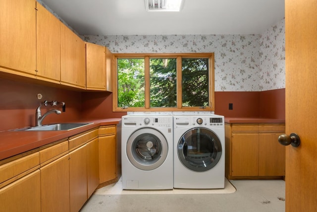 6624 S Ben Burr Rd, Spokane, WA 99223 - washroom featuring cabinet space, wallpapered walls, and separate washer and dryer