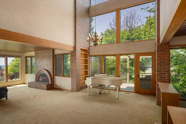 6624 S Ben Burr Rd, Spokane, WA 99223 - unfurnished living room featuring carpet, a high ceiling, healthy amount of natural light, a chandelier, and built in features