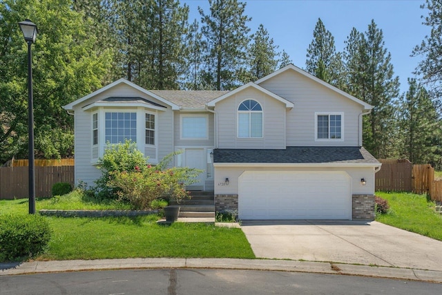 6720 N Royal Ln, Spokane, WA 99208 - view of front of property featuring concrete driveway, a garage, and roof with shingles