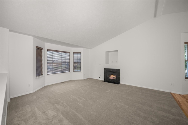 6720 N Royal Ln, Spokane, WA 99208 - unfurnished living room featuring lofted ceiling, a tile fireplace, and carpet