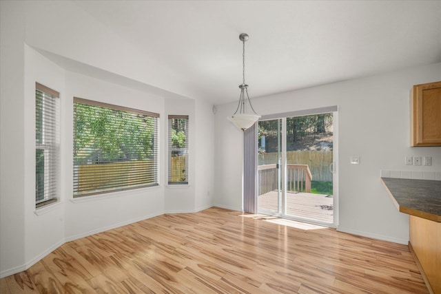 6720 N Royal Ln, Spokane, WA 99208 - unfurnished dining area with light wood-type flooring and healthy amount of natural light