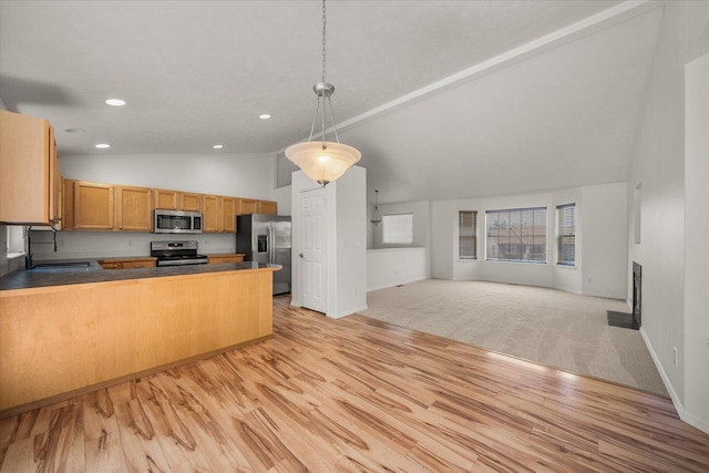 6720 N Royal Ln, Spokane, WA 99208 - kitchen with appliances with stainless steel finishes, vaulted ceiling, open floor plan, a peninsula, and recessed lighting