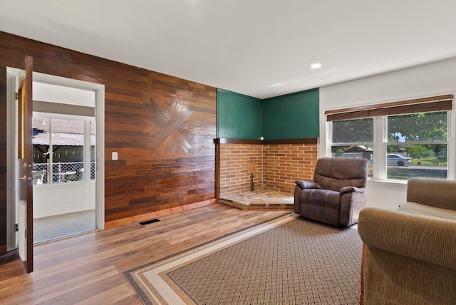 2815 N Bowman Rd, Spokane Valley, WA 99212 - living room featuring wooden walls, light wood-type flooring, recessed lighting, and a brick fireplace