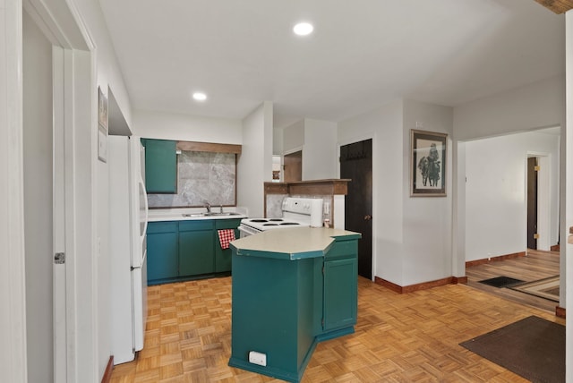 2815 N Bowman Rd, Spokane Valley, WA 99212 - kitchen with green cabinets, white appliances, light countertops, recessed lighting, and a center island