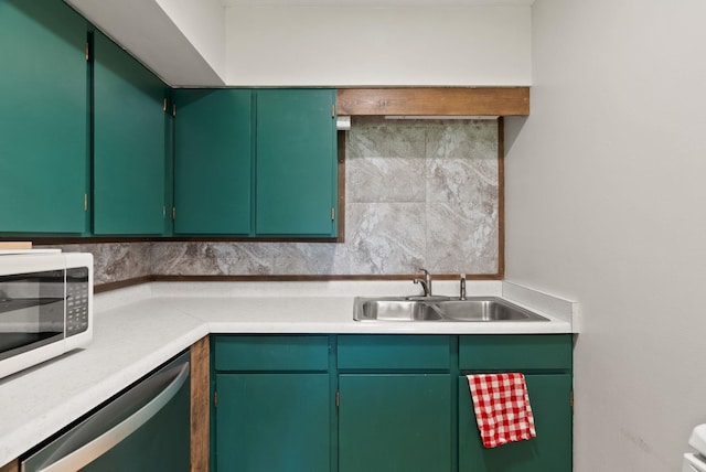 2815 N Bowman Rd, Spokane Valley, WA 99212 - kitchen with appliances with stainless steel finishes, tasteful backsplash, and light countertops
