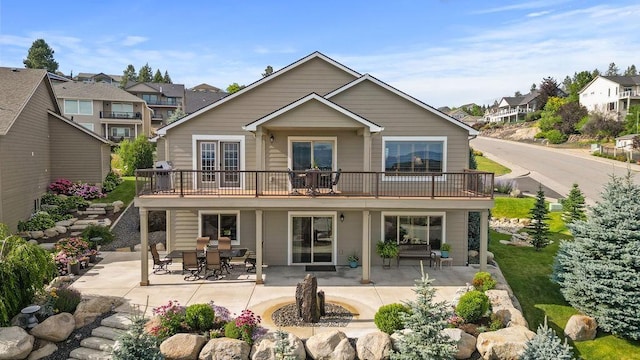 8918 E Clearview Ln, Spokane, WA 99217 - back of property featuring a patio, a residential view, and outdoor dining space