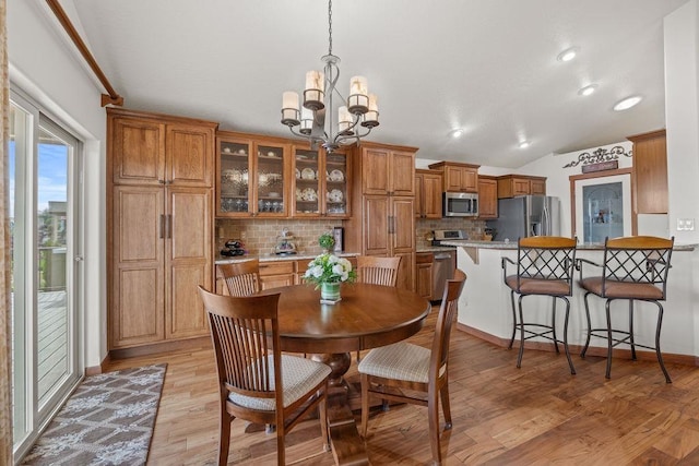 8918 E Clearview Ln, Spokane, WA 99217 - dining room with a chandelier, light wood finished floors, and vaulted ceiling