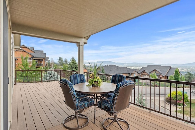 8918 E Clearview Ln, Spokane, WA 99217 - wooden deck with outdoor dining area, a residential view, and a mountain view