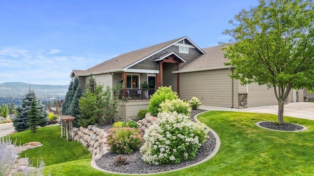 8918 E Clearview Ln, Spokane, WA 99217 - craftsman-style home with a garage, concrete driveway, a front yard, and a mountain view