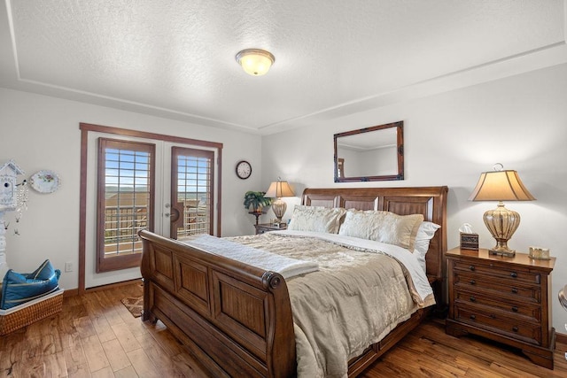 8918 E Clearview Ln, Spokane, WA 99217 - bedroom featuring access to outside, hardwood / wood-style flooring, a textured ceiling, and french doors