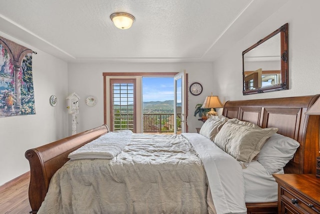 8918 E Clearview Ln, Spokane, WA 99217 - bedroom with wood finished floors and a textured ceiling