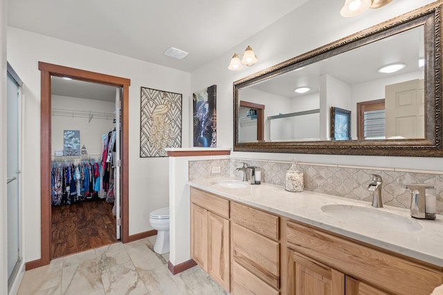 8918 E Clearview Ln, Spokane, WA 99217 - full bath with a stall shower, a spacious closet, marble look tile flooring, double vanity, and tasteful backsplash