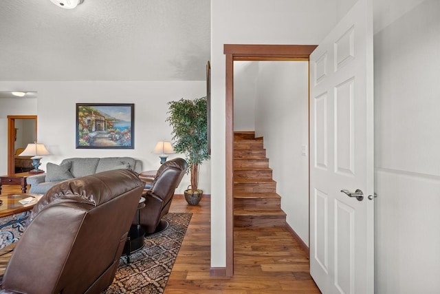 8918 E Clearview Ln, Spokane, WA 99217 - living room featuring wood finished floors, stairs, and a textured ceiling