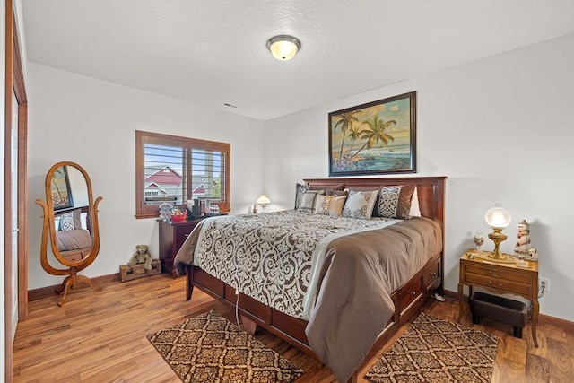 8918 E Clearview Ln, Spokane, WA 99217 - bedroom featuring wood finished floors and a textured ceiling