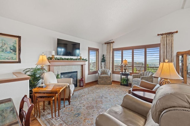 8918 E Clearview Ln, Spokane, WA 99217 - living room featuring vaulted ceiling, wood finished floors, and a tiled fireplace