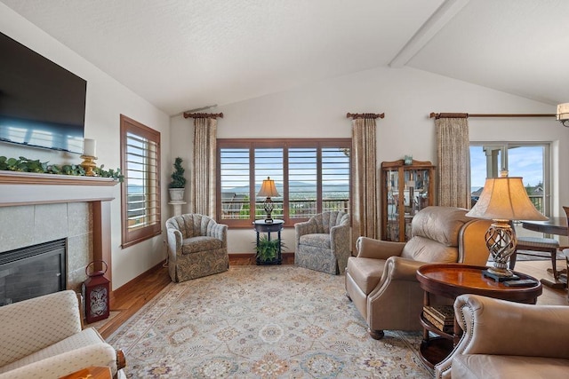 8918 E Clearview Ln, Spokane, WA 99217 - living area with vaulted ceiling, wood finished floors, and a tiled fireplace