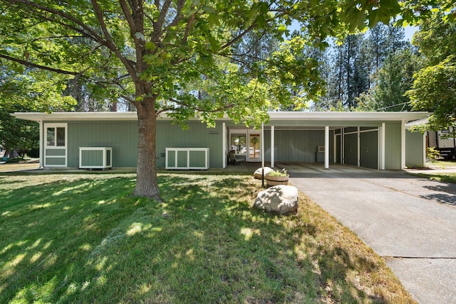 12524 E 20th Ave, Spokane Valley, WA 99216 - view of front of home featuring concrete driveway, a carport, and a front yard