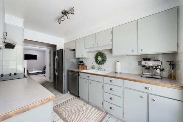 12524 E 20th Ave, Spokane Valley, WA 99216 - kitchen with stainless steel appliances, backsplash, a baseboard radiator, and light countertops