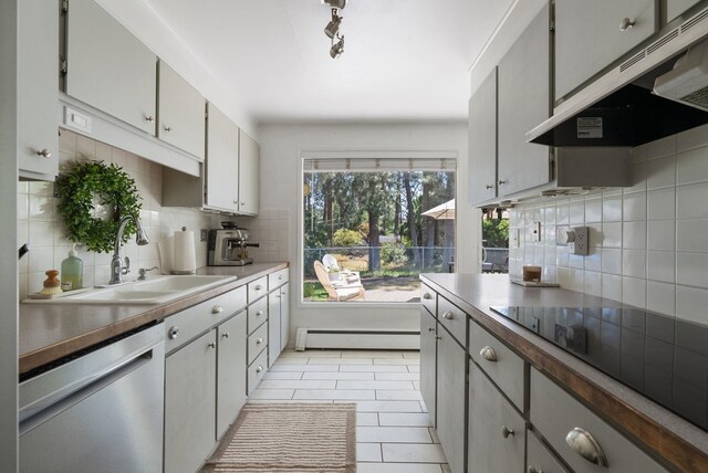 12524 E 20th Ave, Spokane Valley, WA 99216 - kitchen with dishwasher, range hood, a baseboard heating unit, and decorative backsplash