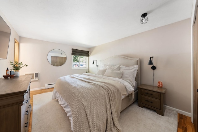 12524 E 20th Ave, Spokane Valley, WA 99216 - bedroom with baseboard heating and light wood-style floors