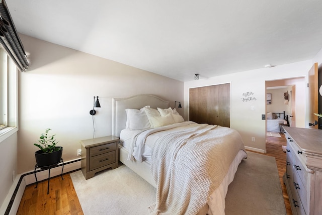 12524 E 20th Ave, Spokane Valley, WA 99216 - bedroom with a baseboard radiator, a closet, and light wood-style floors