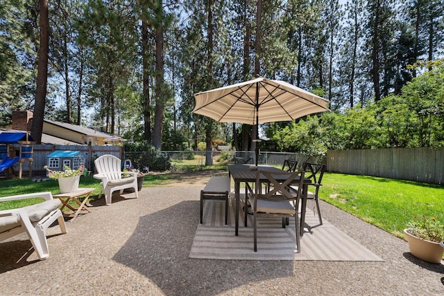 12524 E 20th Ave, Spokane Valley, WA 99216 - fenced backyard featuring outdoor dining space, a patio, and view of wooded area