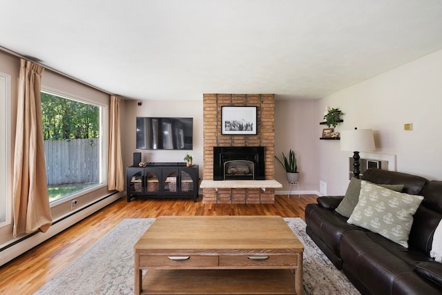 12524 E 20th Ave, Spokane Valley, WA 99216 - living area featuring a baseboard heating unit, wood finished floors, and a brick fireplace