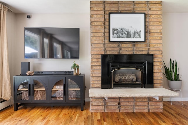 12524 E 20th Ave, Spokane Valley, WA 99216 - living area with wood finished floors, a baseboard radiator, and a fireplace