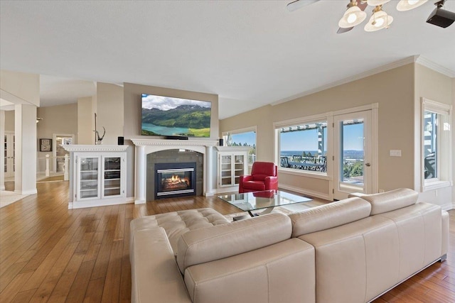 5106 E Glennaire Dr, Spokane, WA 99223 - living area with wood-type flooring, a glass covered fireplace, and ornamental molding