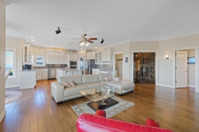 5106 E Glennaire Dr, Spokane, WA 99223 - living room featuring light wood-style floors, a ceiling fan, crown molding, and recessed lighting