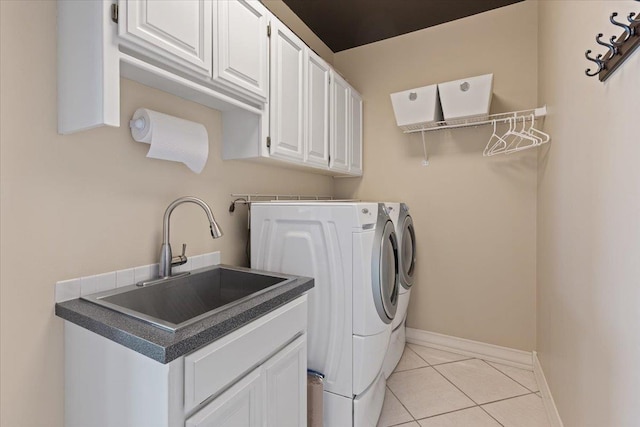 5106 E Glennaire Dr, Spokane, WA 99223 - washroom with washing machine and clothes dryer, light tile patterned floors, and cabinet space