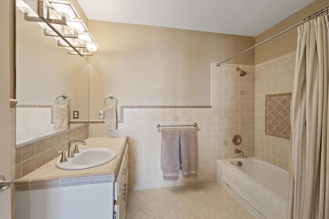 5106 E Glennaire Dr, Spokane, WA 99223 - bathroom with tile patterned floors, shower / bath combo with shower curtain, tile walls, vanity, and wainscoting