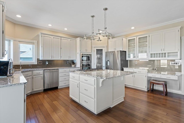 5106 E Glennaire Dr, Spokane, WA 99223 - kitchen with appliances with stainless steel finishes, a center island, crown molding, white cabinets, and tasteful backsplash