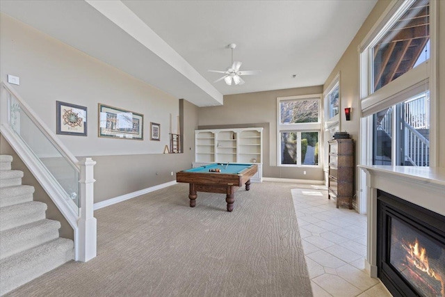 5106 E Glennaire Dr, Spokane, WA 99223 - rec room with light colored carpet, billiards table, a ceiling fan, and a glass covered fireplace