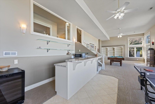 5106 E Glennaire Dr, Spokane, WA 99223 - kitchen featuring carpet, stainless steel microwave, billiards, ceiling fan, and a breakfast bar area