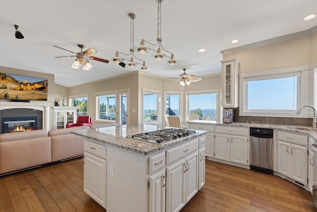 5106 E Glennaire Dr, Spokane, WA 99223 - kitchen with a ceiling fan, stainless steel gas cooktop, plenty of natural light, crown molding, and light wood-type flooring