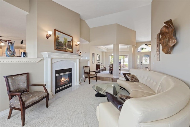 5106 E Glennaire Dr, Spokane, WA 99223 - living area featuring carpet flooring, decorative columns, a glass covered fireplace, and high vaulted ceiling
