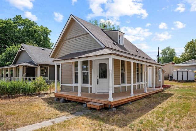 2304 E 6th Ave, Spokane, WA 99202 - rear view of property featuring covered porch, a shed, roof with shingles, and a lawn