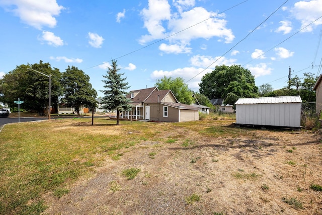 2304 E 6th Ave, Spokane, WA 99202 - view of green lawn featuring a storage shed and an attached garage