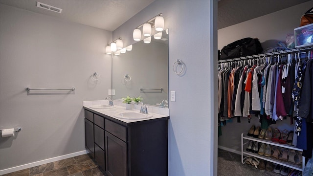 7169 S Parkridge Blvd, Spokane, WA 99224 - bathroom featuring double vanity and a spacious closet