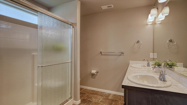 7169 S Parkridge Blvd, Spokane, WA 99224 - bathroom featuring a stall shower, double vanity, and stone finish flooring