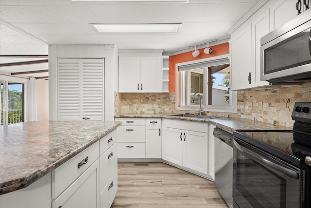 18822 E Montgomery Dr, Otis Orchards, WA 99027 - kitchen featuring appliances with stainless steel finishes, healthy amount of natural light, and white cabinetry