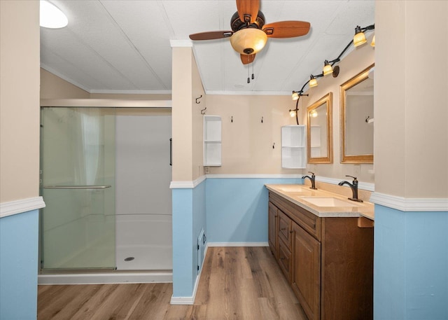 18822 E Montgomery Dr, Otis Orchards, WA 99027 - full bath featuring wood finished floors, ceiling fan, double vanity, a shower stall, and ornamental molding