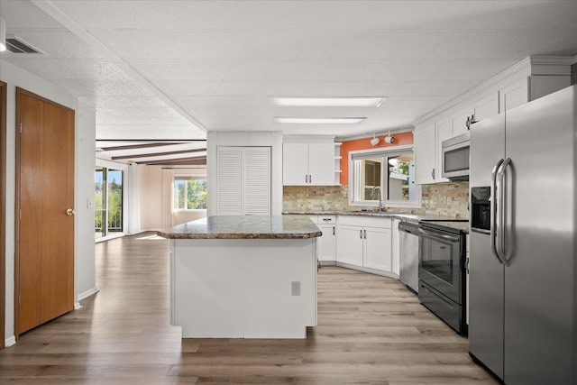 18822 E Montgomery Dr, Otis Orchards, WA 99027 - kitchen featuring appliances with stainless steel finishes, white cabinetry, tasteful backsplash, and plenty of natural light