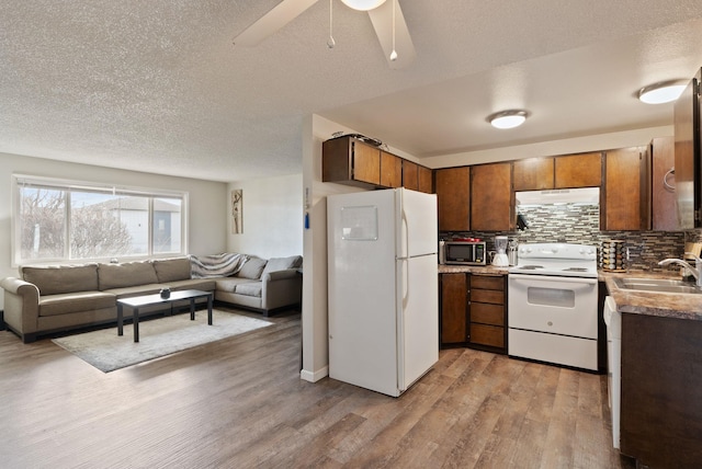 2117 E Euclid Avenue 2119E Euclid Ave, Spokane, WA 99207 - kitchen with white appliances, open floor plan, light wood finished floors, decorative backsplash, and a textured ceiling