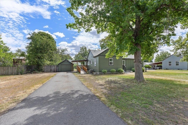 2224 N Lily Rd, Spokane, WA 99212 - view of front facade with asphalt driveway, an outdoor structure, and a detached garage