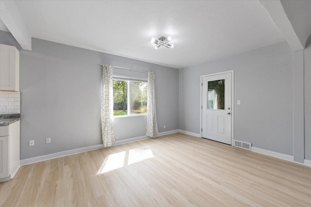 2224 N Lily Rd, Spokane, WA 99212 - unfurnished living room with light wood-style floors and baseboards