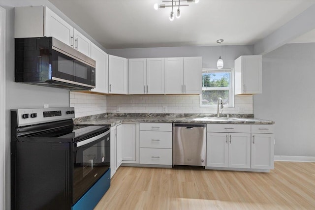 2224 N Lily Rd, Spokane, WA 99212 - kitchen featuring stainless steel appliances, light wood-style flooring, white cabinets, and decorative backsplash