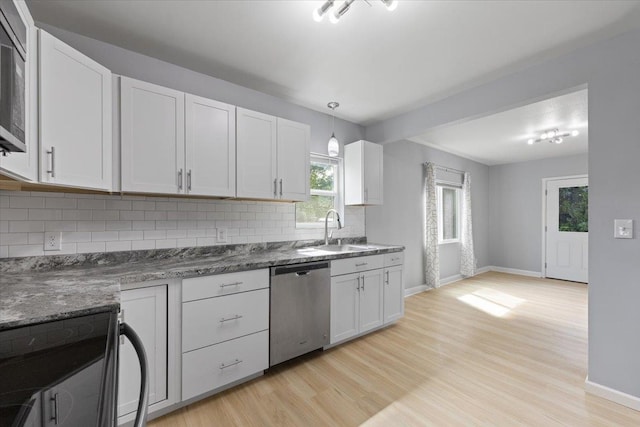 2224 N Lily Rd, Spokane, WA 99212 - kitchen with appliances with stainless steel finishes, decorative backsplash, light wood finished floors, and white cabinets
