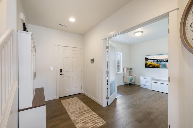 1024 W Staples Rd, Post Falls, ID 83854 - foyer entrance featuring dark wood-style floors and baseboards